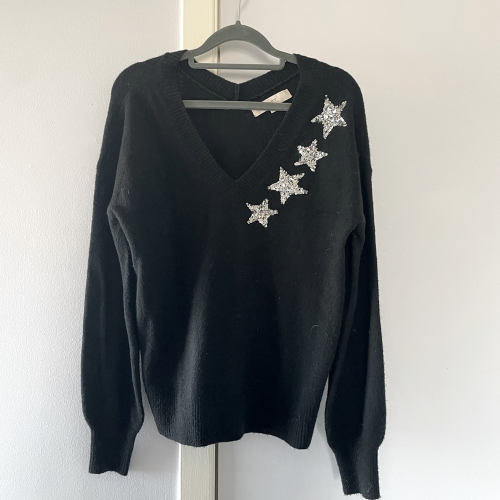 Black sweater with silver stars.